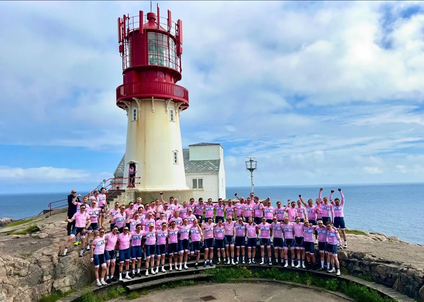 Syklistene i rosa drakter jubler foran Lindesnes fyr